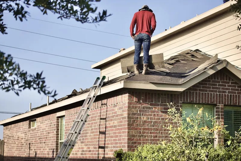 Professional roofer working on a residential roof in Deer Run South